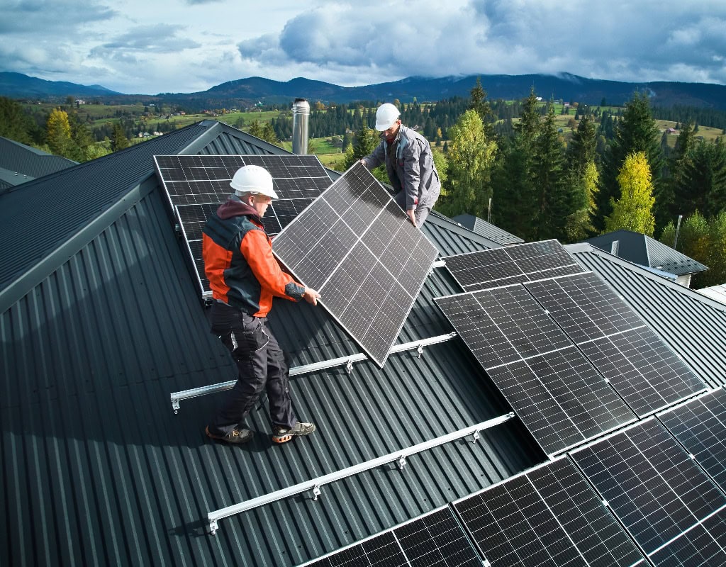 Techniker tragen Photovoltaik-Solarmodule bei der Installation einer Solaranlage